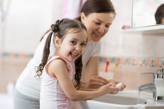 Mother and Daughter washing their hands Mother and Daughter washing their hands