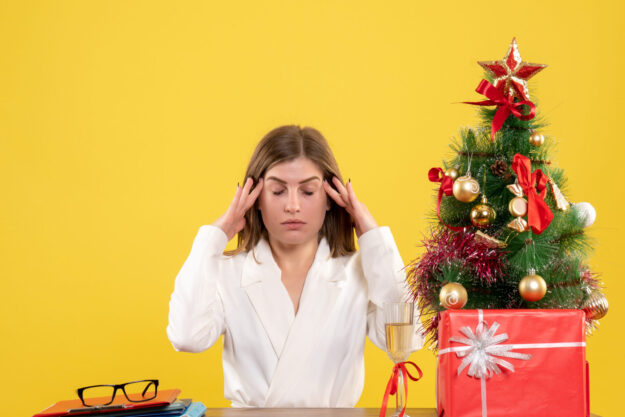 front-view-female-doctor-sitting-front-her-table-yellow-background