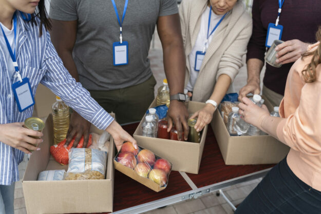 group-different-people-volunteering-foodbank-poor-people Volunteering during this season can be great for your mental health!