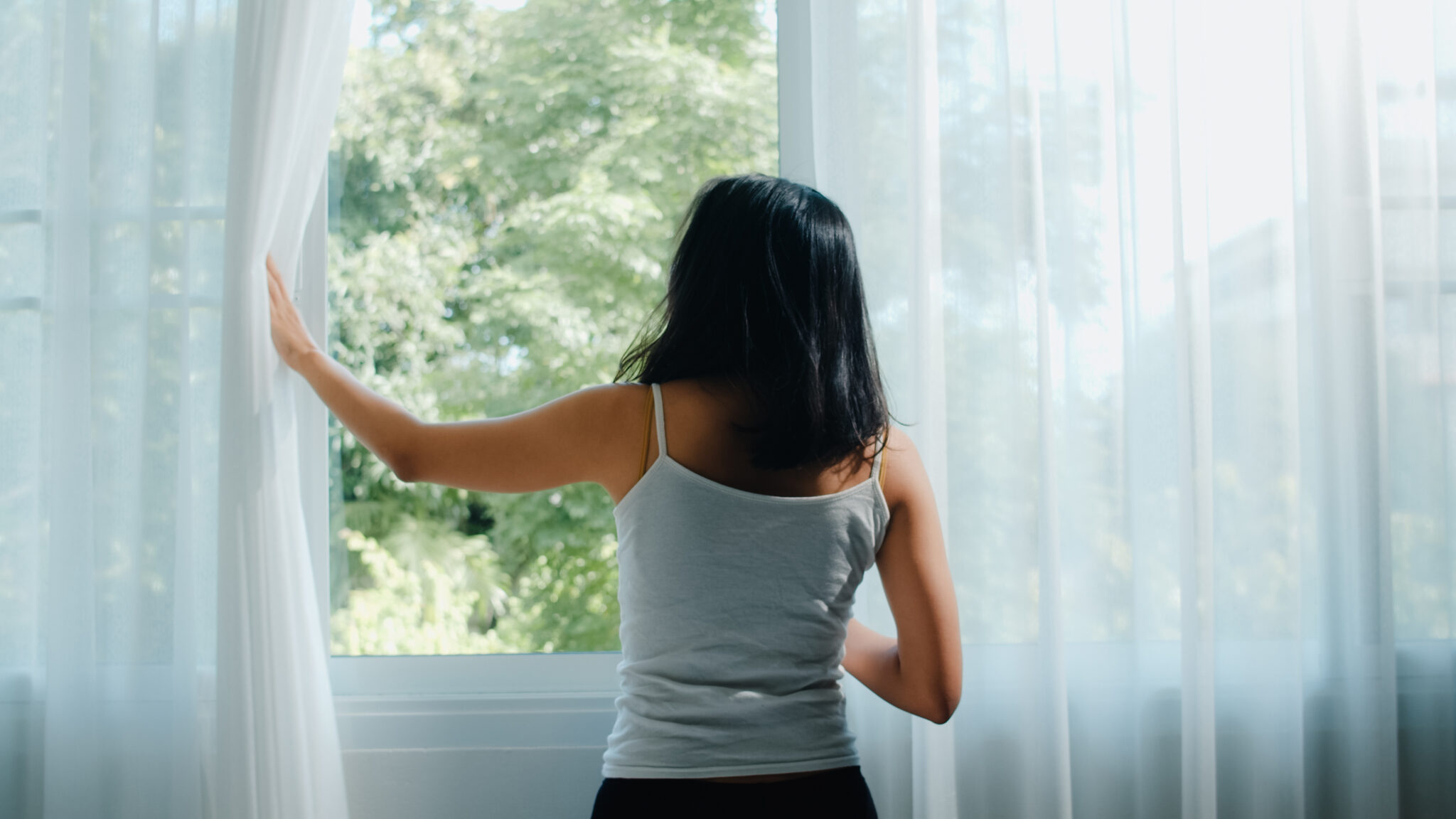 woman with seasonal allergies stuck inside during spring.