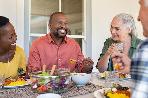 Man Eating with Friends